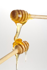 Honey dripping from a wooden honey dippers