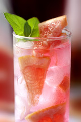 Fresh and cold ice tea with sliced grapefruit and mint