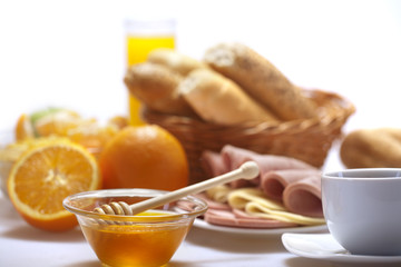 Breakfast with coffee, bread, honey,  juice, egg