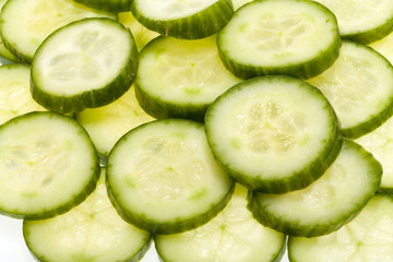 Freshly sliced cucumber  isolated on white background