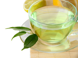 Transparent cup of green tea with lemon