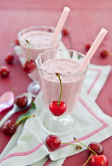 Two glasses with cherry milkshake