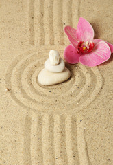 Fototapeta na wymiar Zen garden with raked sand and round stones close up
