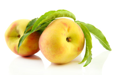 Ripe sweet peaches with leaves, isolated on white