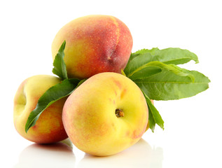 Fototapeta na wymiar Ripe sweet peaches with leaves, isolated on white