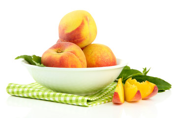 Ripe sweet peaches in bowl, isolated on white