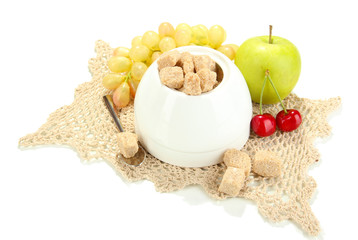 Unrefined sugar in white sugar bowl on grey background