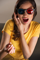 Expressive young woman watching 3d film