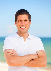 Handsome young man at beach background