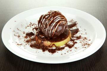 Chocolate dessert on big plate on wooden table
