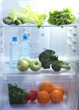 Open refrigerator with vegetarian food