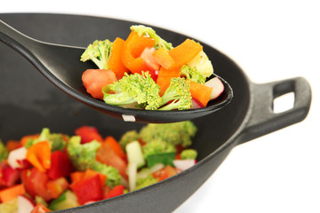 Vegetable ragout in wok, isolated on white