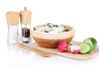 Vitamin vegetable salad in wooden bowl isolated on white
