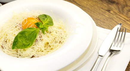 spaghetti with egg on a plate in a restaurant
