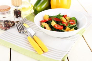 Light salad in plate on wooden table
