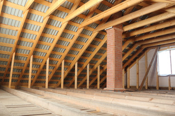 Roof frame covered by profiled metal sheet and brick chimney