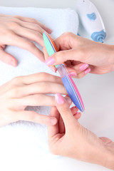 Man doing manicure in salon