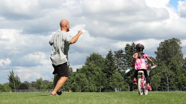 Father Celebrates Daughter Riding Bike Without Training Wheels