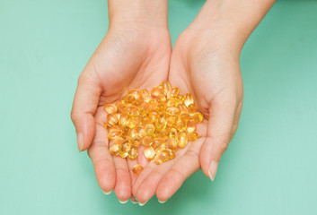 Vitamin Omega-3 fish oil capsules on a hand