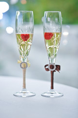 .Two wedding glasses of groom and bride on the table