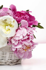 Lush peonies in white basket