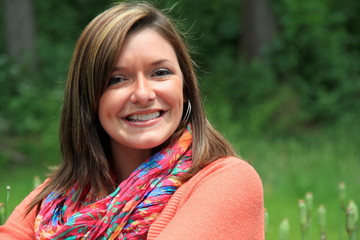 Pretty young woman in bright sweater and scarf