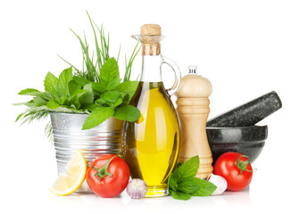 Fresh herbs, tomato, olive oil and pepper shaker