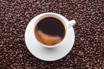 Coffee cup on a coffee grains background