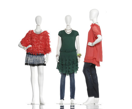 female mannequins in red clothes and green on three background