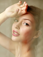 Naklejka premium A beautiful woman, portrait isolated on grey background