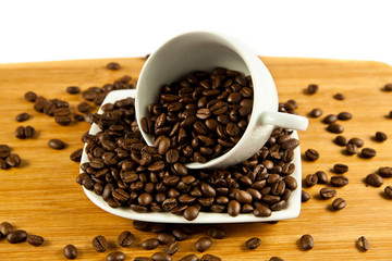 beans of  coffee and cup on the plate