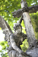 The statue of a beautiful angel with a Christian cross