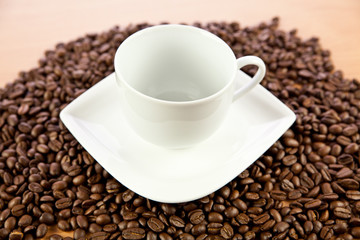 beans of  coffee and cup on the plate