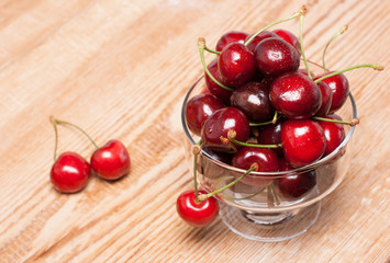 ripe cherries in a transparent bowl