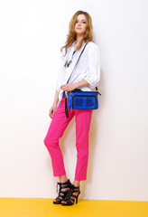 Young beautiful in stylish woman with bag isolated