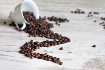 Cup of coffee with beans on retro vintage white planks concept