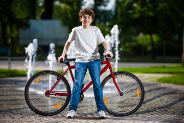 Fototapeta premium Urban biking - teenage boy and bike in city