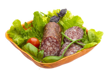 Ripe salami with salad, basil, onion and tomato