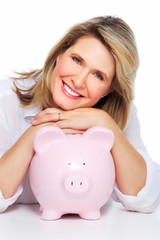 Senior woman with a piggy bank.