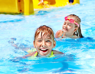 Children on water slide at aquapark.