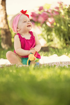 Portrait of cute little baby girl playing in the garden