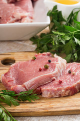 Fresh raw meat on wooden background with pepper