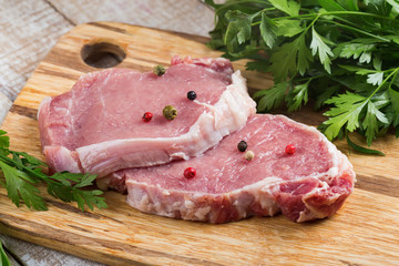 Fresh raw meat on wooden background with pepper