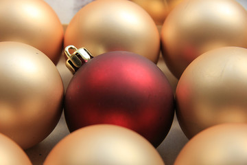 Red ornament on a pile of golden ornaments