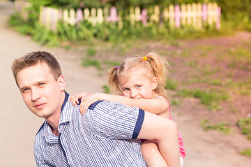 Happy father and daughter playing in the park