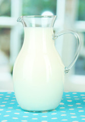 Pitcher of milk on table in room