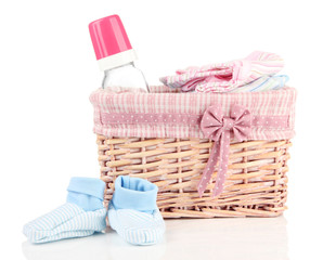 Obraz na płótnie Canvas Beautiful basket of baby clothes isolated on white