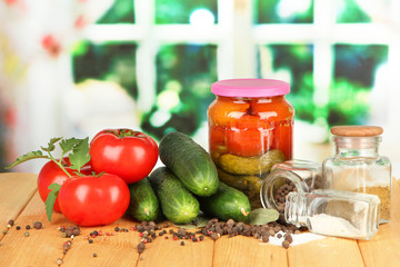 Tasty  fresh and canned cucumbers and red tomatoes,