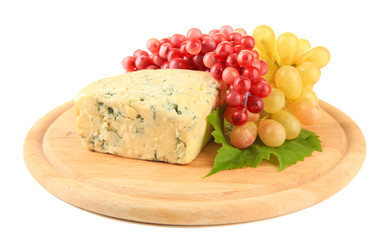 Tasty blue cheese and grape on cutting board, isolated on white