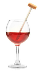 Glass of wine with thermometer, isolated on white